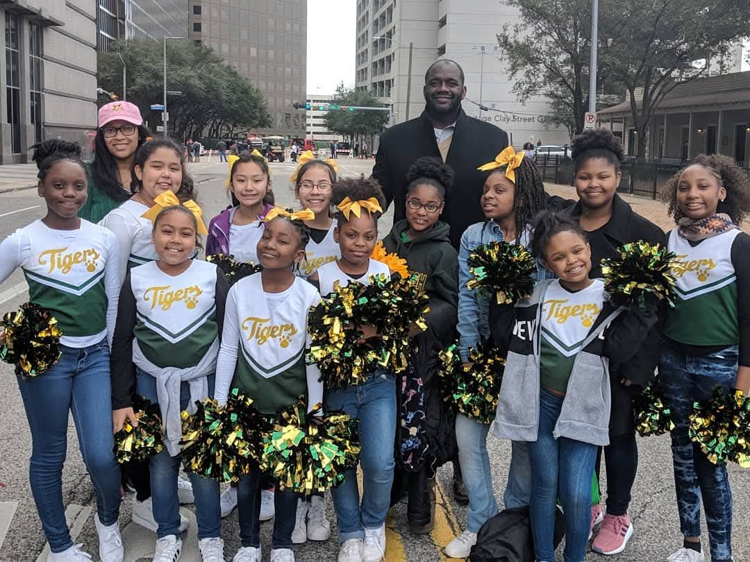 Jerry Davis with the Tigers youth cheer squad in downtown Houston
